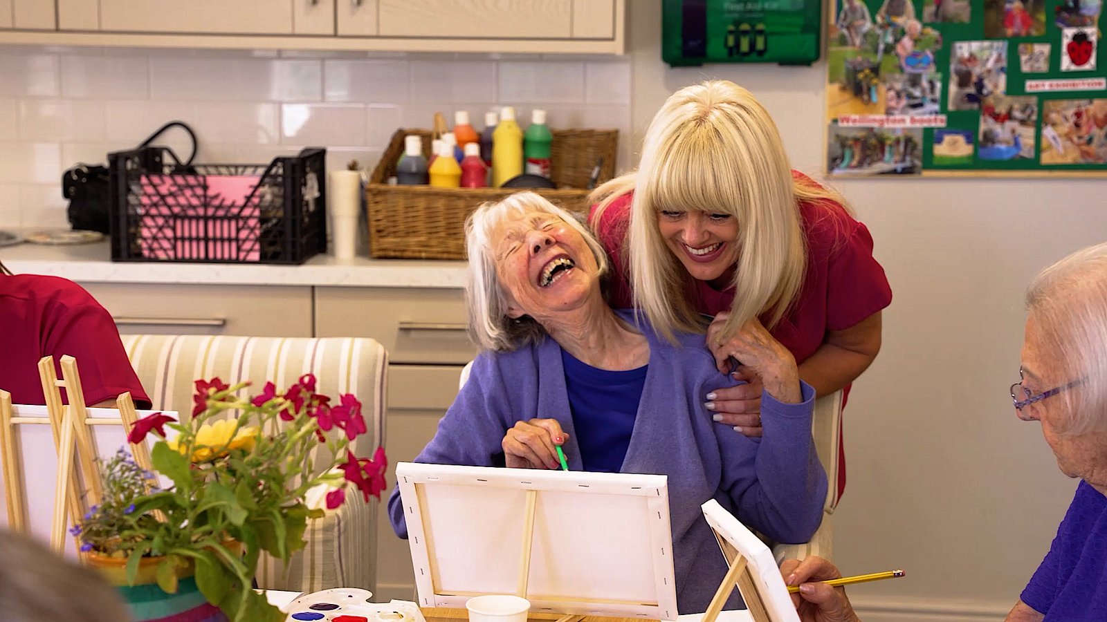 care home carer interacting with resident laughing